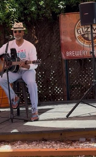Mike Gaskins entertaining a live audience with acoustic music