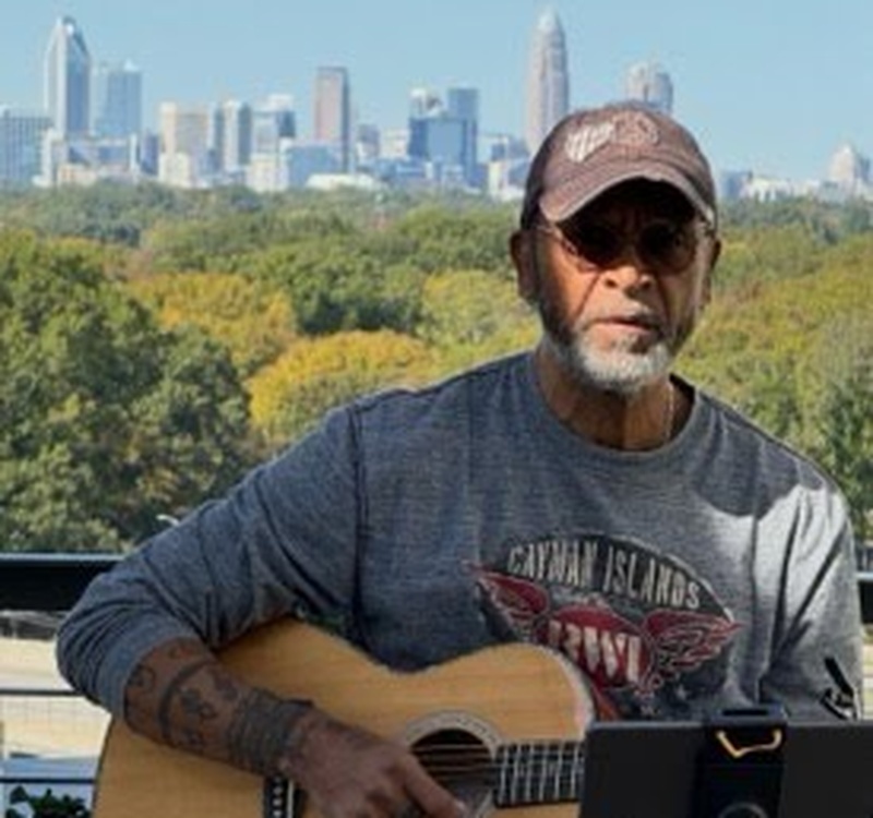 Mike Gaskins performing solo acoustic guitar at a live event