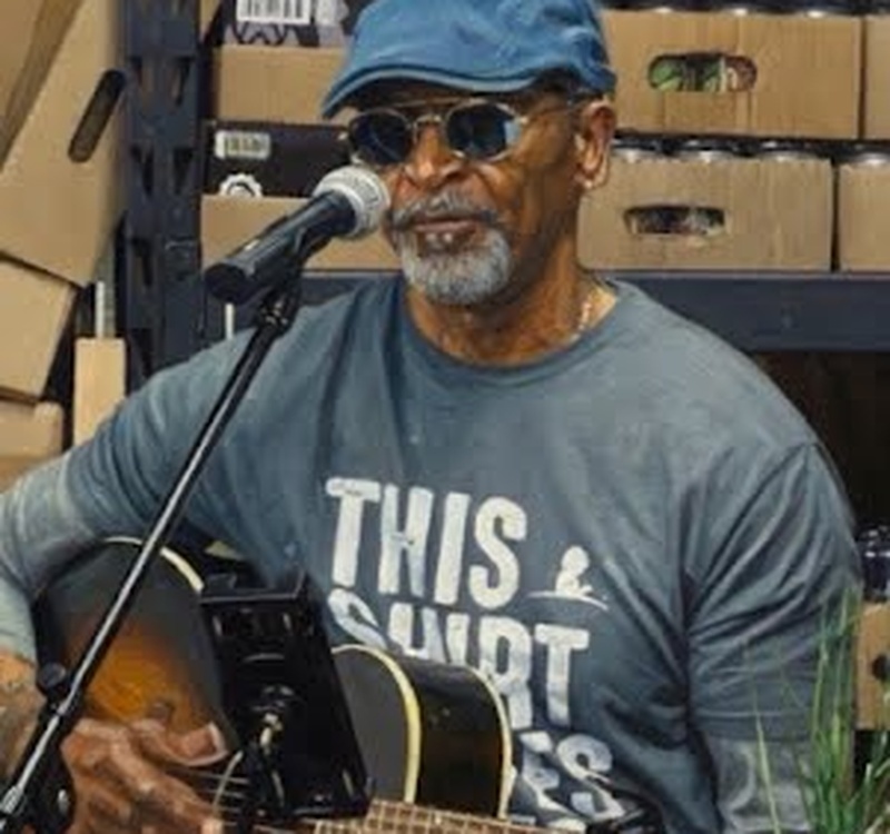 Outdoor live acoustic music performance by Mike Gaskins
